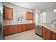 Well-lit kitchen with light wood cabinetry, stainless steel appliances, and tile backsplash at 15803 Fairview Pt, Tavares, FL 32778