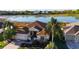 Beautiful home with water view, mature palms, pristine landscaping, and tile roof at 1721 Carrera Dr, The Villages, FL 32159