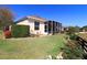 Beautiful backyard showcasing lush landscaping, a screened-in patio, and manicured lawn at 1721 Carrera Dr, The Villages, FL 32159