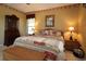 Comfortable bedroom with wicker furniture, lamp lighting, and quilted bedding at 1721 Carrera Dr, The Villages, FL 32159