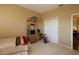 Bedroom includes an exercise bike, closet, and shelving unit for storage at 1721 Carrera Dr, The Villages, FL 32159