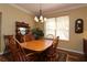 Bright dining room showcasing a wooden table and traditional furnishings at 1721 Carrera Dr, The Villages, FL 32159