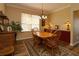 Sunlit dining room with a traditional table, chairs and period furniture at 1721 Carrera Dr, The Villages, FL 32159