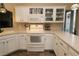 Well-lit kitchen with white cabinets, modern appliances, and decorative tile backsplash at 1721 Carrera Dr, The Villages, FL 32159