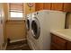 Laundry room with stacked washer/dryer unit and a practical sink at 1721 Carrera Dr, The Villages, FL 32159