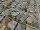An aerial view shows the location of the house with a defined red line in a residential neighborhood at 1829 Foxwood Ln, The Villages, FL 32162