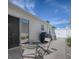 Inviting backyard with a patio table set, BBQ, and white picket fence at 1829 Foxwood Ln, The Villages, FL 32162