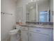 Modern bathroom featuring white cabinets, granite countertops, and a glass-enclosed shower at 1829 Foxwood Ln, The Villages, FL 32162