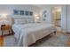 Comfortable bedroom with a plush bed, hardwood floors, and view to the ensuite bathroom at 1829 Foxwood Ln, The Villages, FL 32162