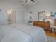 Bright bedroom featuring hardwood floors, ensuite bathroom, and ceiling fan at 1829 Foxwood Ln, The Villages, FL 32162