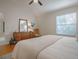 Comfortable bedroom featuring hardwood floors, a window, and a ceiling fan at 1829 Foxwood Ln, The Villages, FL 32162