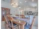Bright dining room features a stylish chandelier, wood table with seating for six, and access to the kitchen at 1829 Foxwood Ln, The Villages, FL 32162