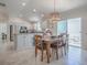 Open dining area features a table for six and a stylish chandelier with sliding glass doors to the patio at 1829 Foxwood Ln, The Villages, FL 32162