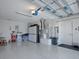 Well-organized garage with sealed floors, storage cabinets, and a garage door opener at 1829 Foxwood Ln, The Villages, FL 32162