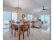 Open concept living and dining room featuring a dining table for six, sectional sofa, and views to the lanai at 1829 Foxwood Ln, The Villages, FL 32162