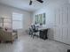 Bright office with a ceiling fan, neutral color palette, and large window at 1829 Foxwood Ln, The Villages, FL 32162