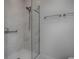 Walk-in shower featuring glass enclosure, showerhead, and grab bars at 1829 Foxwood Ln, The Villages, FL 32162