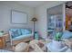 Cozy sunroom featuring comfortable seating, neutral tones, and a decorative floor lamp at 1829 Foxwood Ln, The Villages, FL 32162