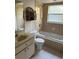 Bathroom featuring a bathtub, shower, toilet and vanity sink at 1903 Lake Ella Rd, Fruitland Park, FL 34731