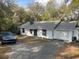 Exterior view of home with mature trees, grey car, and driveway at 1903 Lake Ella Rd, Fruitland Park, FL 34731