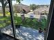 Backyard patio with seating and green lawn space, viewed through sliding glass doors at 202 Compass Rose Dr, Groveland, FL 34736