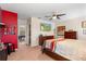 The carpeted bedroom has a ceiling fan and features a TV, dark furniture, and adjacent room at 202 Compass Rose Dr, Groveland, FL 34736