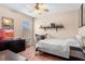 A bedroom featuring neutral walls, a ceiling fan, and a window providing plenty of natural light at 202 Compass Rose Dr, Groveland, FL 34736