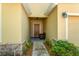 Warm entryway featuring a covered porch, stone accents, and decorative plants at 202 Compass Rose Dr, Groveland, FL 34736