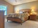 Cozy bedroom featuring a comfortable bed with warm lighting and neutral decor at 2523 Mariel Way, The Villages, FL 32162