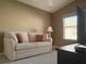Comfortable sitting area with beige couch and flat screen TV at 2523 Mariel Way, The Villages, FL 32162