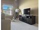 Inviting living room with large TV and exercise equipment at 2523 Mariel Way, The Villages, FL 32162