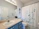 Charming bathroom with a vanity, floral shower curtain, and coordinating decor at 25239 River Crest Dr, Leesburg, FL 34748