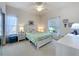 Cozy bedroom with neutral decor, a comfortable bed, and natural light from the window at 25239 River Crest Dr, Leesburg, FL 34748