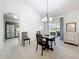 Elegant dining area with an open layout, neutral tones, and view of the outdoor patio at 25239 River Crest Dr, Leesburg, FL 34748