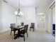 Dining room with a dark wood table and chairs, chandelier, and access to the kitchen at 25239 River Crest Dr, Leesburg, FL 34748