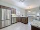 Well-equipped kitchen with stainless steel appliances, wood cabinetry, and bright lighting at 25239 River Crest Dr, Leesburg, FL 34748