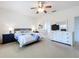 Bright and airy main bedroom with a ceiling fan and an en-suite bathroom at 25239 River Crest Dr, Leesburg, FL 34748