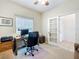 Bright office with a view features a computer desk, office chair, and french door at 25239 River Crest Dr, Leesburg, FL 34748