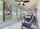 Relaxing sunroom features views of backyard, tile floor, and comfortable furniture at 25239 River Crest Dr, Leesburg, FL 34748