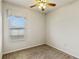 Cozy carpeted bedroom featuring a ceiling fan and a bright window at 3341 Winchester Estates Cir, Lakeland, FL 33810