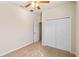 Bedroom features a closet, door, ceiling fan, and neutral carpet at 3341 Winchester Estates Cir, Lakeland, FL 33810