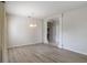 Open dining room features modern chandelier and archway leading to other rooms in a home with light colored wood flooring at 3341 Winchester Estates Cir, Lakeland, FL 33810