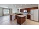 Well-lit kitchen showcases a center island, tiled floors, and modern appliances at 3341 Winchester Estates Cir, Lakeland, FL 33810