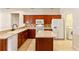 Well-lit kitchen with wood cabinetry, island, and stainless steel appliances at 3341 Winchester Estates Cir, Lakeland, FL 33810