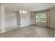 Bright and airy living room with ample natural light from large windows and stylish, light-colored wood flooring at 3341 Winchester Estates Cir, Lakeland, FL 33810