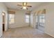 Primary bedroom with neutral carpet, ceiling fan, windows and access to screened in lanai at 3341 Winchester Estates Cir, Lakeland, FL 33810