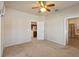 Primary bedroom with neutral carpet, ceiling fan, and en suite bathroom at 3341 Winchester Estates Cir, Lakeland, FL 33810