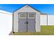 Backyard storage shed with double doors and decorative windows for added appeal at 3341 Winchester Estates Cir, Lakeland, FL 33810