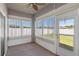 Cozy sunroom featuring ceiling fan, carpet, many windows providing lots of natural light, and access to the backyard at 3341 Winchester Estates Cir, Lakeland, FL 33810