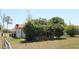Backyard view showing property with partial privacy hedge at 5221 Se 107Th Pl, Belleview, FL 34420